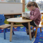 Girl Reading a Book in the Library