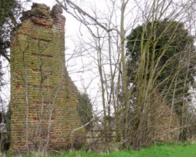 Old stone ruin obscured amongst some trees